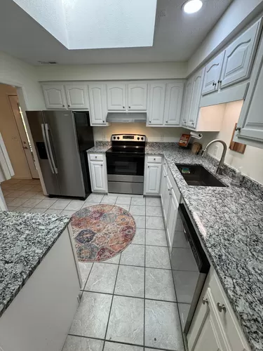 Kitchen with new stainless appliances and granite counters - 12 Sand Dollar Ct