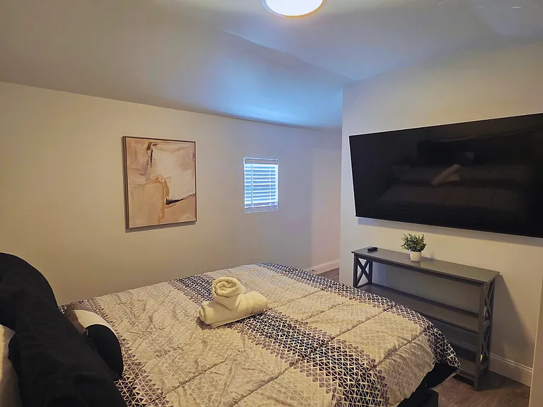Well-lit bedroom with decor that creates a warm ambiance