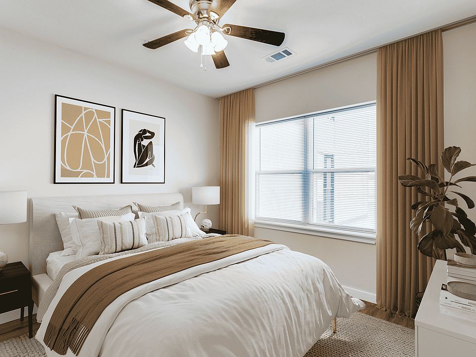 Enjoy serene living with this stylishly decorated bedroom featuring modern art and ample lighting.