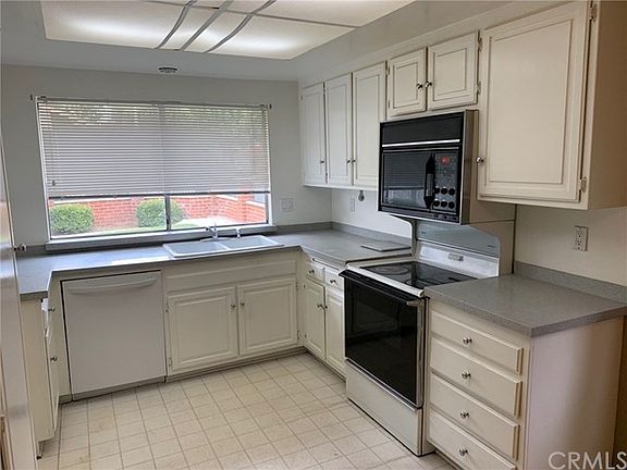 Bright kitchen has a view of front yard.