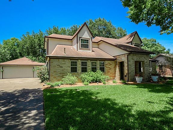 The detached garage behind the house allows for a long driveway to provide ample space for parking.