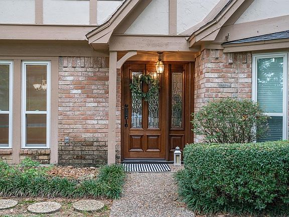 Charming leaded glass and solid wood front door with transome welcomes your guests.