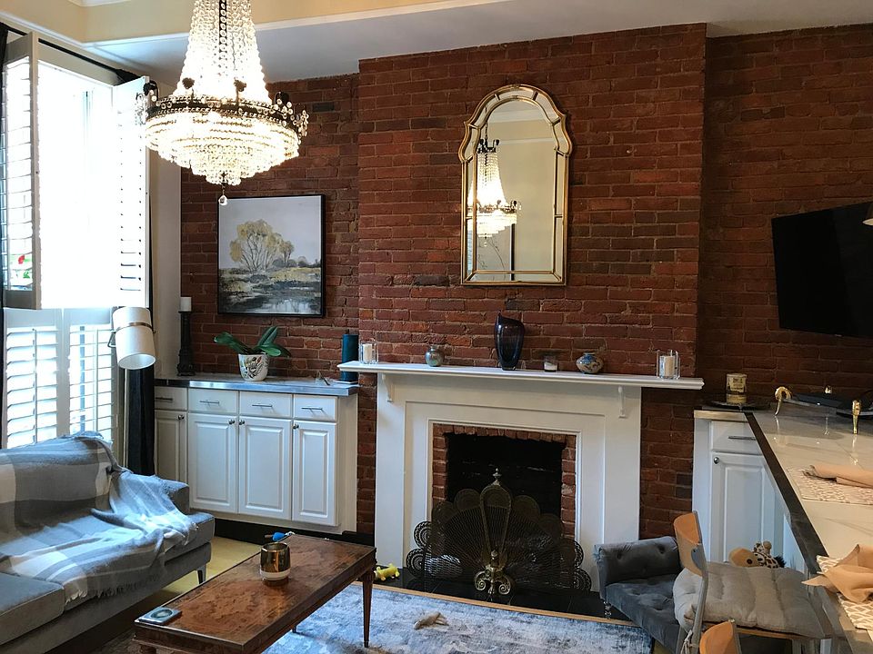 Sunny and bright 6 ft windows with plantation shutters. Antique crystal chandelier.