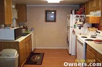 Range Stays. Laminate Flooring. Oak Cabinet