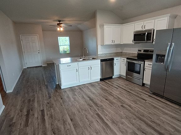 Kitchen features stainless steel appliances and granite countertops