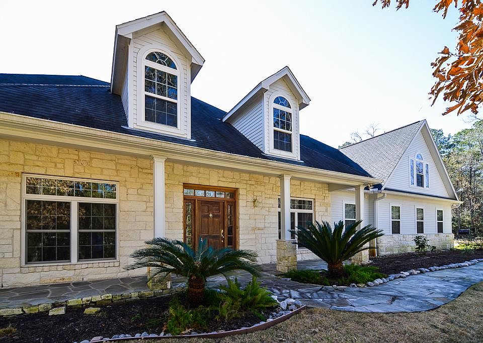 Front view of this custom stone and cement board home