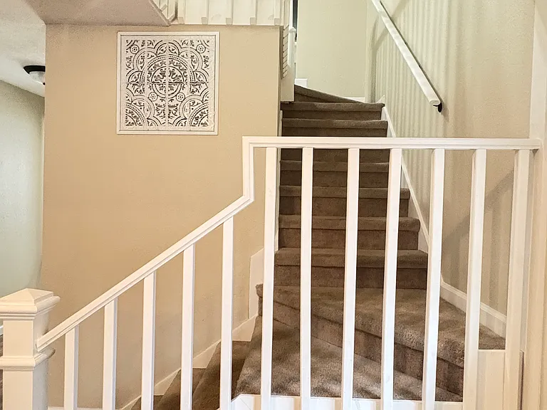 The staircase railings add timeless charm and provide the perfect place to drape garland during the holidays. Even the air return has been thoughtfully transformed into a charming architectural feature.