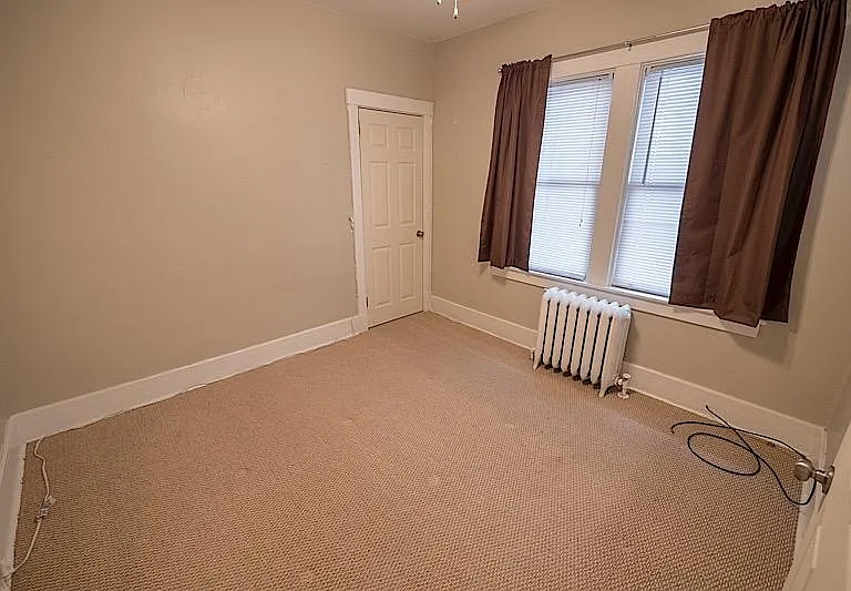 Bedroom with a nice size closet and windows, wall to wall newer carpet.