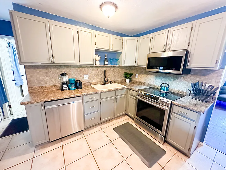 Cook Up a Storm! ____ _ Discover your inner chef in our well-stocked kitchen, featuring utensils and kitchenware. Enjoy meals with family or friends at the spacious 6-seater dining table.