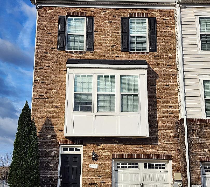 Three level end-unit townhouse with attached deck and fenced-in back yard.