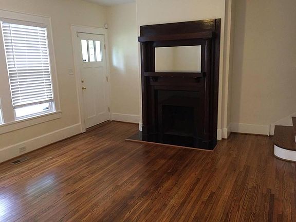 Vintage fireplace in living room. All floors refinished to p