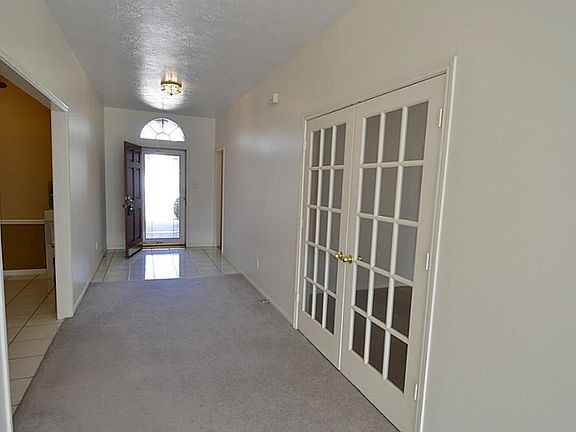 A view from the Family room entry to the home the corridor leads to the huge kitchen and French Doors to the Office.