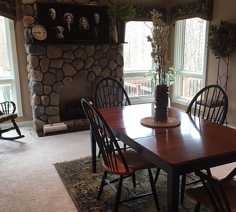 This living space is currently being used as a formal dining room.  The fireplace here is gas. New carpet here too!