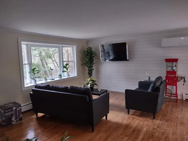 Living Area Nicely Furnished with Large Screen TV