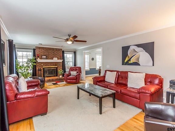 Hardwood floor, crown molding, wood-burning fireplace, paddle fan