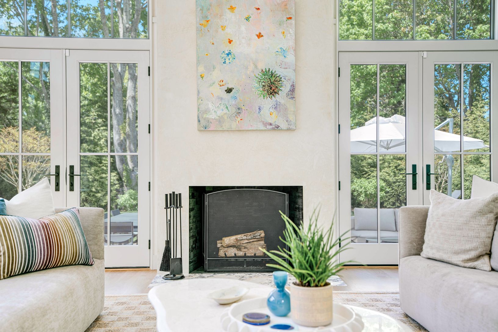 Double sided fireplace flanked by french doors to pool area
