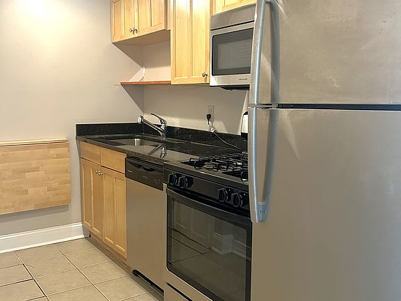 Fully equip Kitchen w/ stainless steel appliances, granite counter top, and wall table.