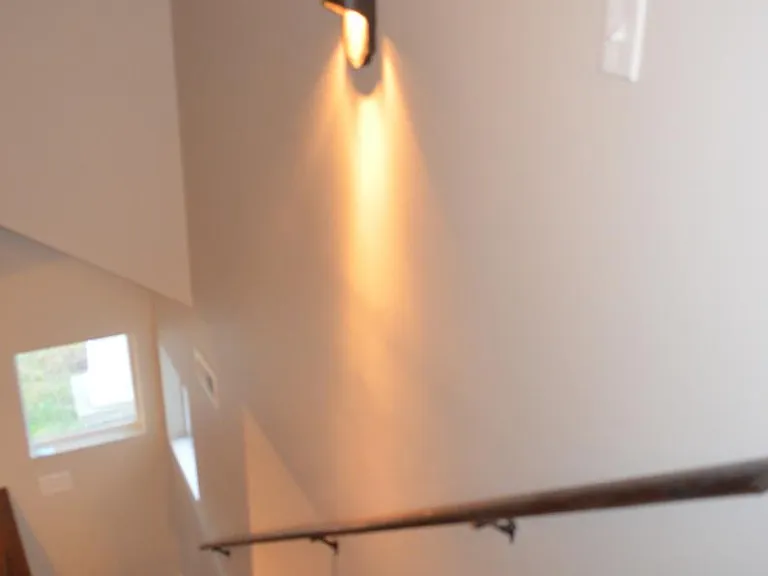 Stairs with custom lighting and hardwood .