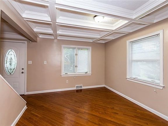 Dining Room with coffered ceiling and hardwood floors.