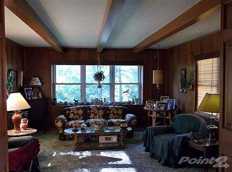 The first floor family room features lots of windows, nice wood paneling and beamed ceiling.  There's plenty of room for the whole family to gather together.