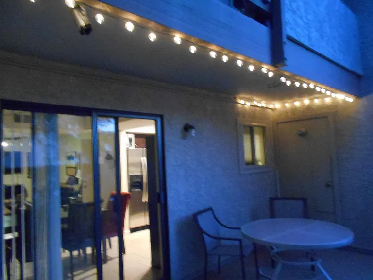 Patio at night, Table 5 chairs, BBQ Grill