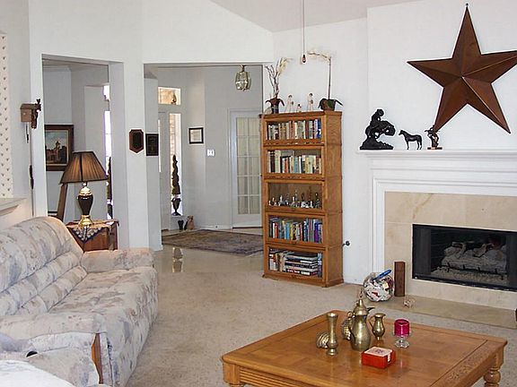 Alternate view of great room or den which shows the gas log fireplace and breakfast bar to the left