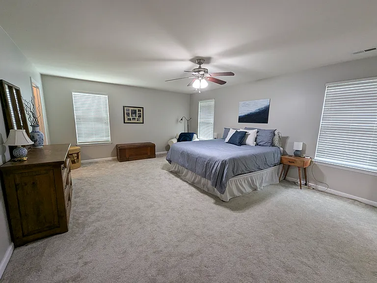 primary bedroom with 2 walk in closets. One closet off bedroom to back left of picture. Other walk in closet off primary bathroom. (Aprox 21'x15.5')