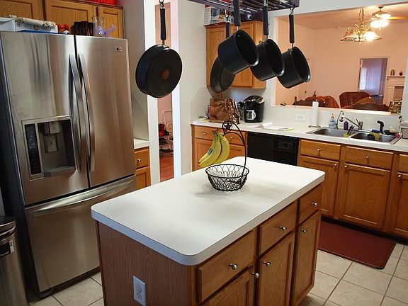 Whip up your favorite meals in this island kitchen showcasing gas cooking, serving bar, pantry, and 