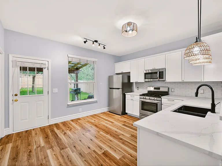 Kitchen opens up to backyard.