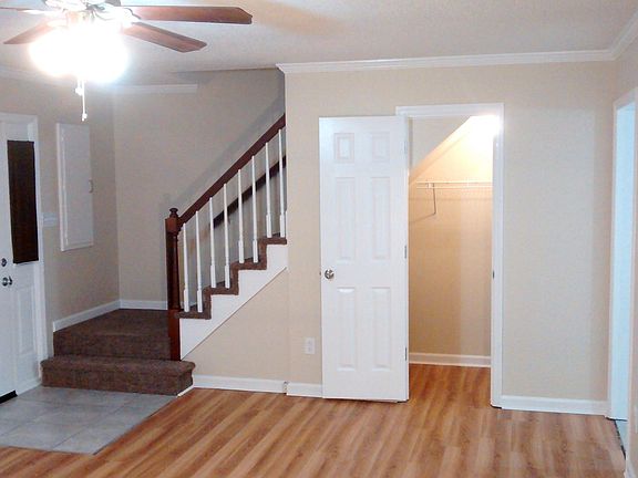 Living room has storage area under stairway.