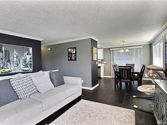 Living Room Flows into Dining Room and Sliding Glass Door Leading to Patio.