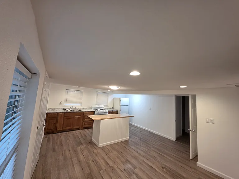 Kitchen with island, gas stove and fridge