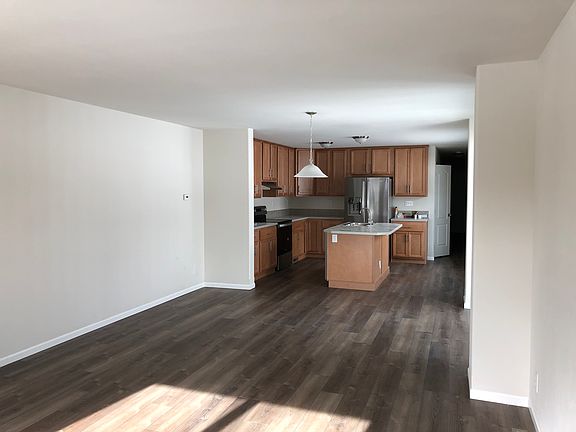 Open plan living area, looking through to kitchen.