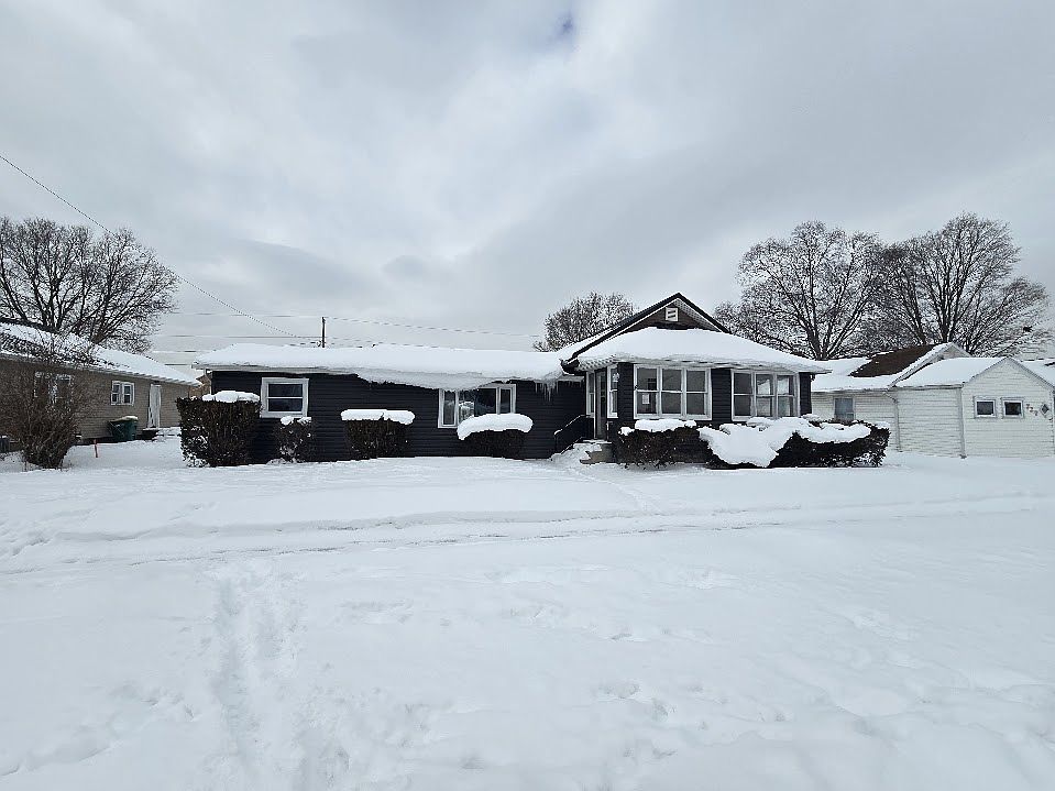 Vinyl siding topped with a metal roof and new windows on a double lot in Mishawaka. Easy walk to Gibbard Park. Less than a mile to Martin's Supermarket, Marion HS, and IUSB.