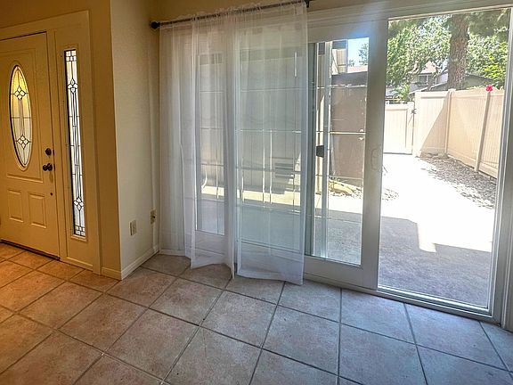 Living area with slider doors offers access to front patio for ample light and a cross-breeze