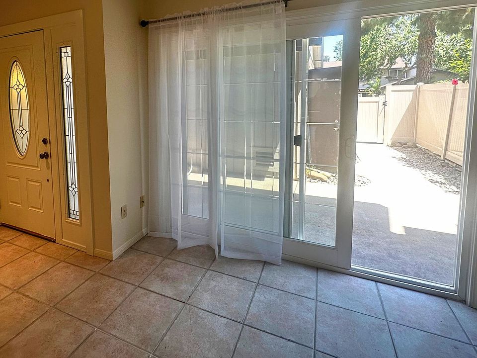 Living area with slider doors offers access to front patio for ample light and a cross-breeze