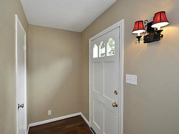 Front foyer features hard wood floors, updated fixture & coat closet.