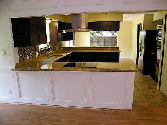 A Complete NEW Kitchen was Installed including Granite, Stainless Steel Appliances, Stainless Hood and Gorgeous Rich Wood Cabs!