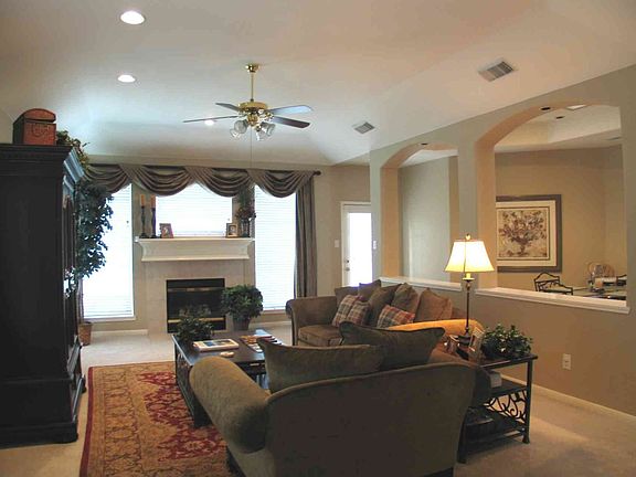 Family Room overlooking golf course with direct-vent fireplace.
