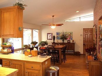 The large dining area is open to the kitchen. There is a gas log fireplace in the dining area, hardwood flooring and access to the covered patio. Great for entertaining!!