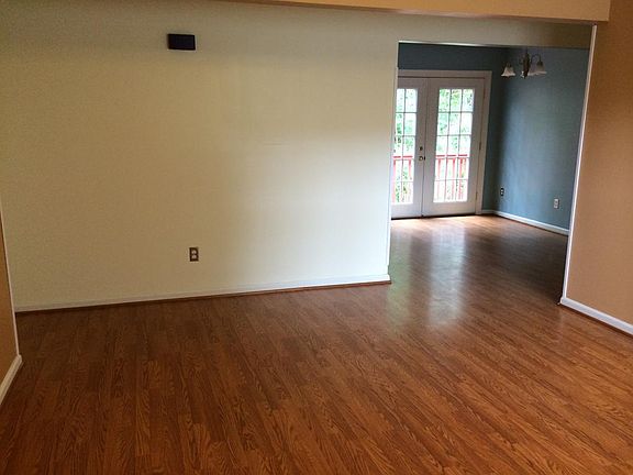 looking through living room into dining room, then doors to 