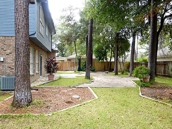 Lovely bricked patios & garden space galore plus a storage building!