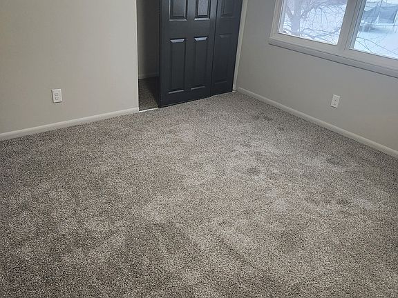 Room #2. Freshly painted walls and new carpet.