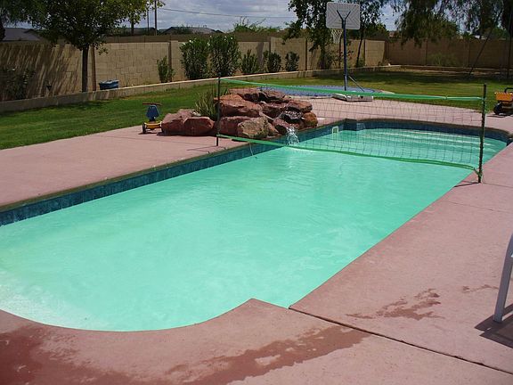 Back yard swimming pool with in-ground trampoline