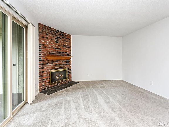 Spacious living room with cozy wood-burning fireplace.