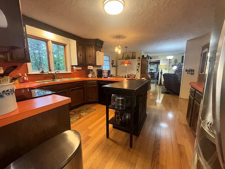 Large Kitchen with table for dining.