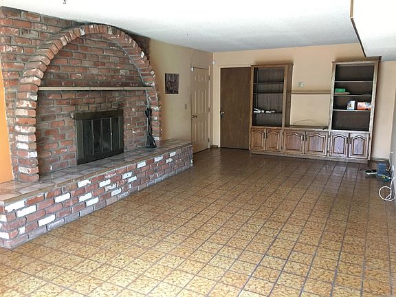 Family with fireplace and built in storage. Entire house flooring is tile or wood. No carpeting.
