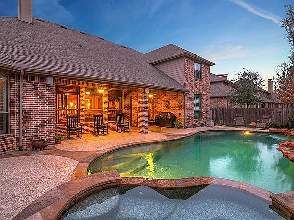 View of backyard from the hot tub. Hot tub features a waterfall effect into pool. What an ideal entertaining space to enjoy all year!