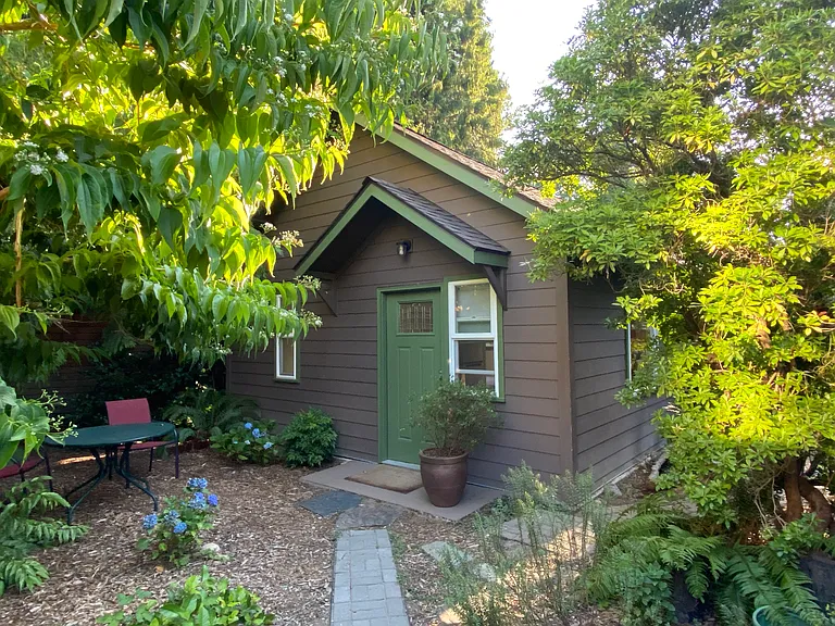 Studio cottage is surrounded by cedar trees