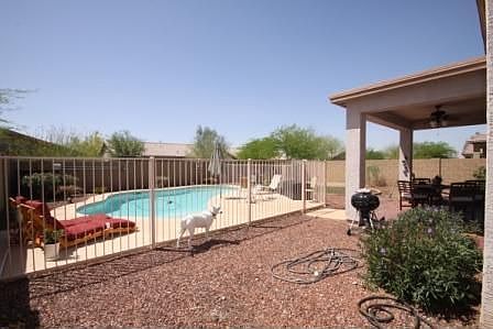 Backyard with fenced pool